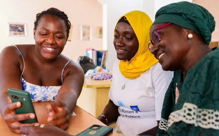 Three women looking at a smart phone