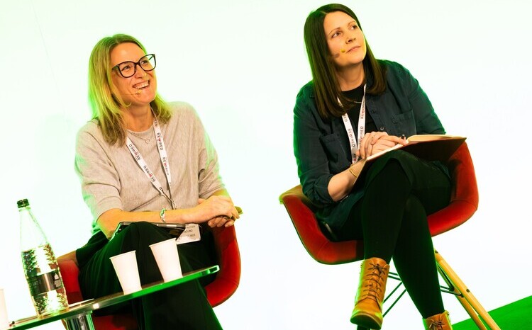 Liz Clow and Rachel Hope sitting in chairs on the stage at Digital Health Rewired